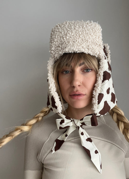 Quilted brown cow and sherpa trapper hat